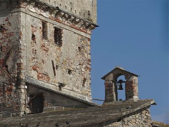 Low angle view of bell tower against clear sky