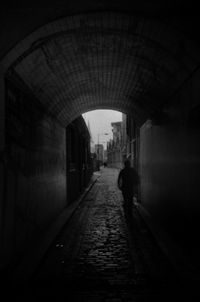 Man walking in tunnel