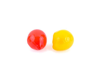 Close-up of yellow tomatoes over white background