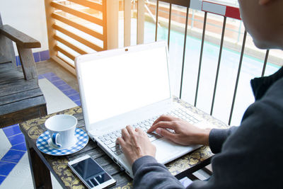 Low angle view of man working on table at cafe