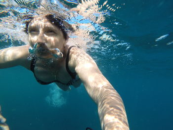 Close-up of mature woman swimming in sea