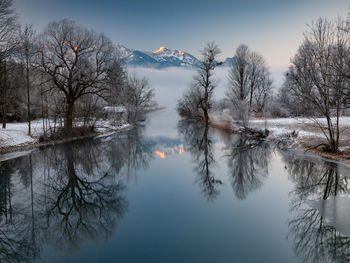 Scenic view of lake against sky during winter