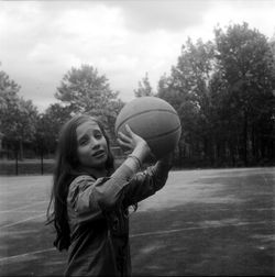 Portrait of girl holding basket ball