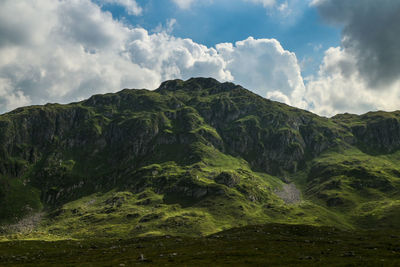 Low angle view of waterfall against sky