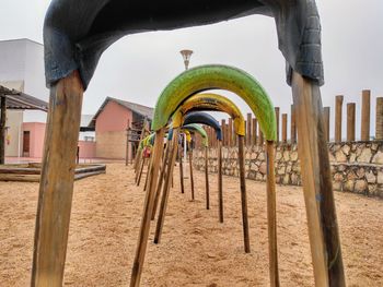 Low angle view of playground against buildings