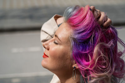 Close-up portrait of woman with multi colored hair