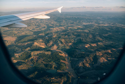 Aerial view of landscape seen through airplane window