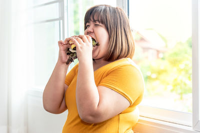 Side view of woman eating food