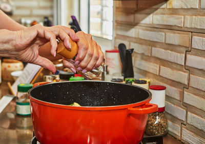 Cropped hand of man preparing food