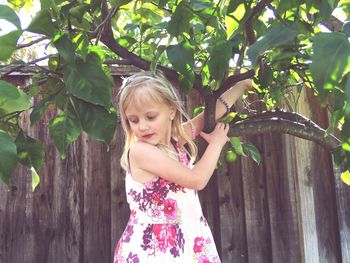 Cute girl holding lemon tree branches
