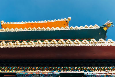 Low angle view of multi colored roof against sky