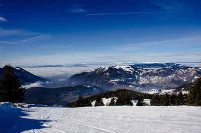 Scenic view of mountains against blue sky