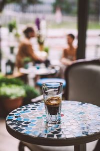 Close-up of espresso in glass on table