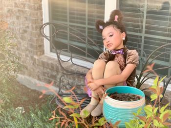 Woman looking away while sitting in yard