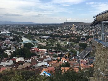 High angle view of city against cloudy sky