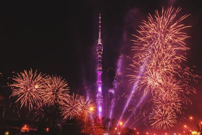 Low angle view of firework display at night