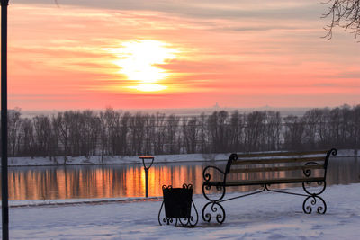 View of bench in park during sunset