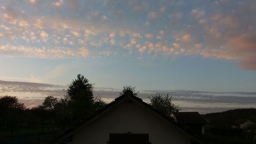 Silhouette house against sky during sunset