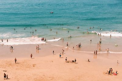 High angle view of people enjoying at beach