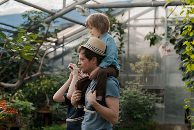 Adventurous family inspecting tropical gallery in botanical garden. local travel