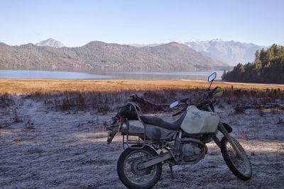 Bicycles on lake against mountain range
