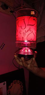 Close-up of hand holding illuminated lighting equipment