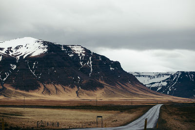 Scenic view of mountains against cloudy sky