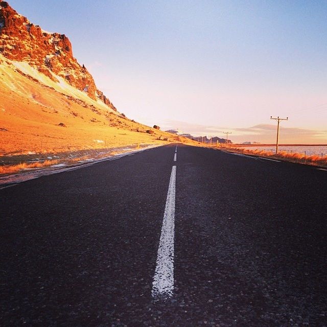 the way forward, transportation, road, diminishing perspective, road marking, vanishing point, clear sky, asphalt, empty road, copy space, long, country road, empty, tranquility, tranquil scene, sky, landscape, mountain, surface level, scenics