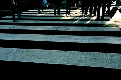 Low section of people walking on road