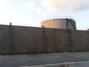 Low angle view of building against cloudy sky