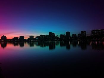 Reflection of buildings in city at night