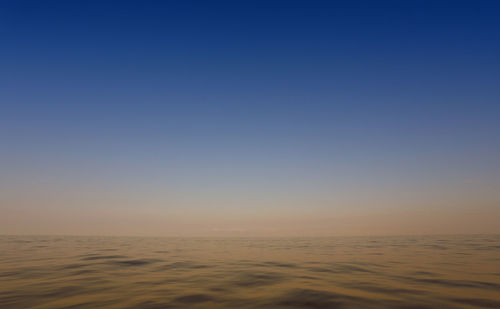 Scenic view of sea against clear sky during sunset