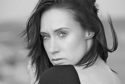 Close-up portrait of young woman looking away