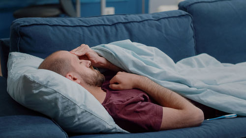 High angle view of woman sleeping on bed at home