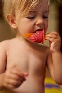 Close-up of shirtless boy eating food