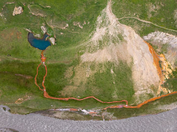 Digital composite image of man on rock