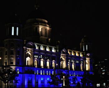 Low angle view of illuminated building at night