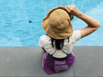 High angle view of girl standing by swimming pool