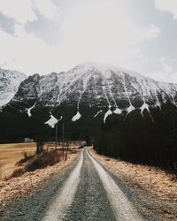 Road passing through snow covered mountains