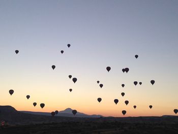 Scenic view of hot air balloons flying in sky