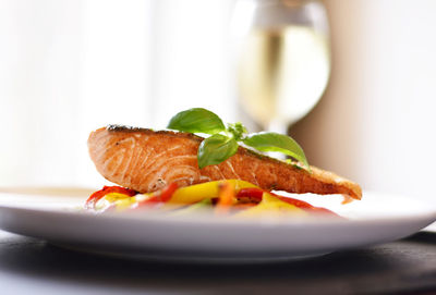 Close-up of orange slice in plate on table