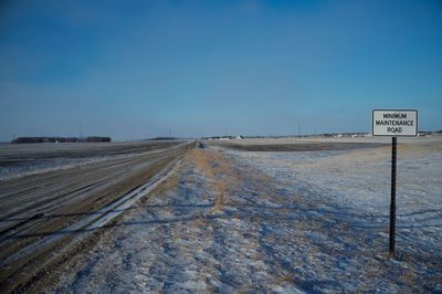 Dirt road against clear sky