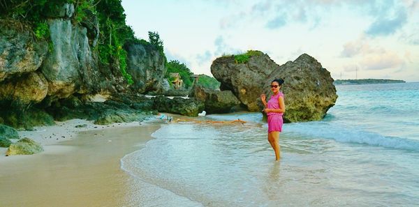 Rear view of woman standing on beach