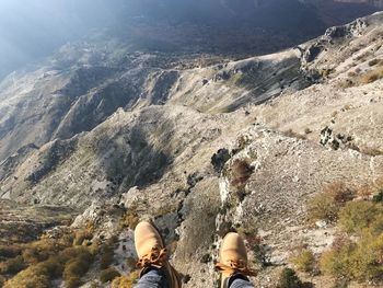 Low section of man standing on mountain