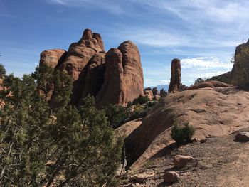 Rock formations on landscape against sky