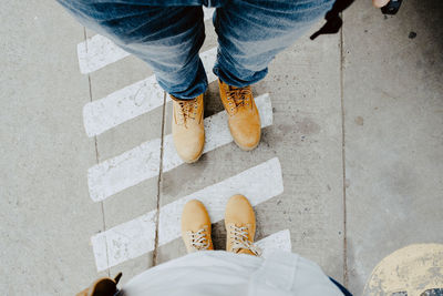 Low section of people standing on road