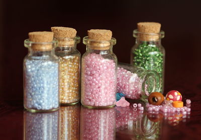 Close-up of colorful beads in bottles