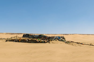 Scenic view of desert against clear blue sky