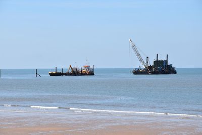 Ship in sea against clear sky