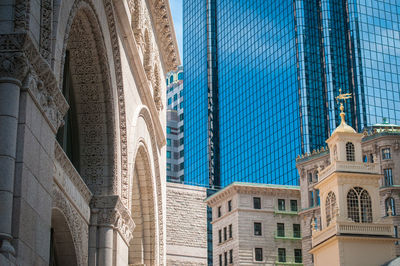 Low angle view of buildings against skyscraper